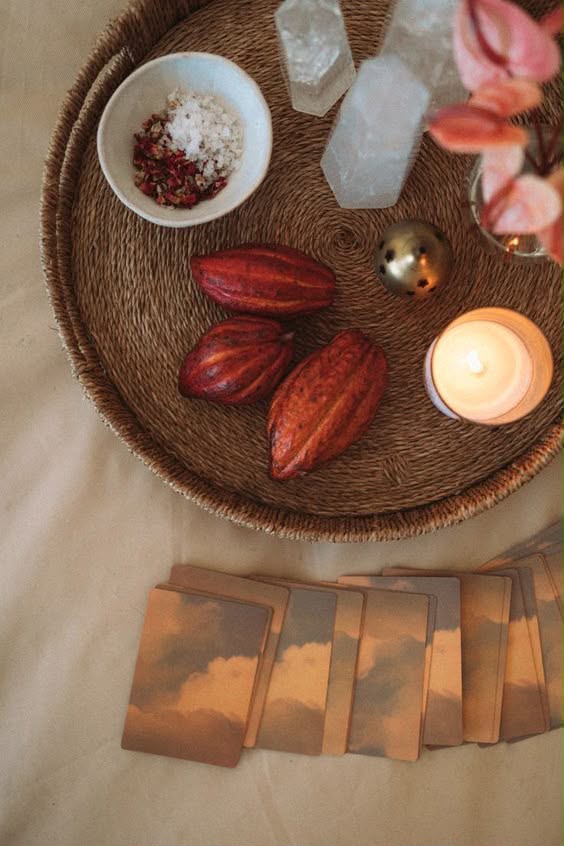 Woven tray with cacao pods, crystals and a candle